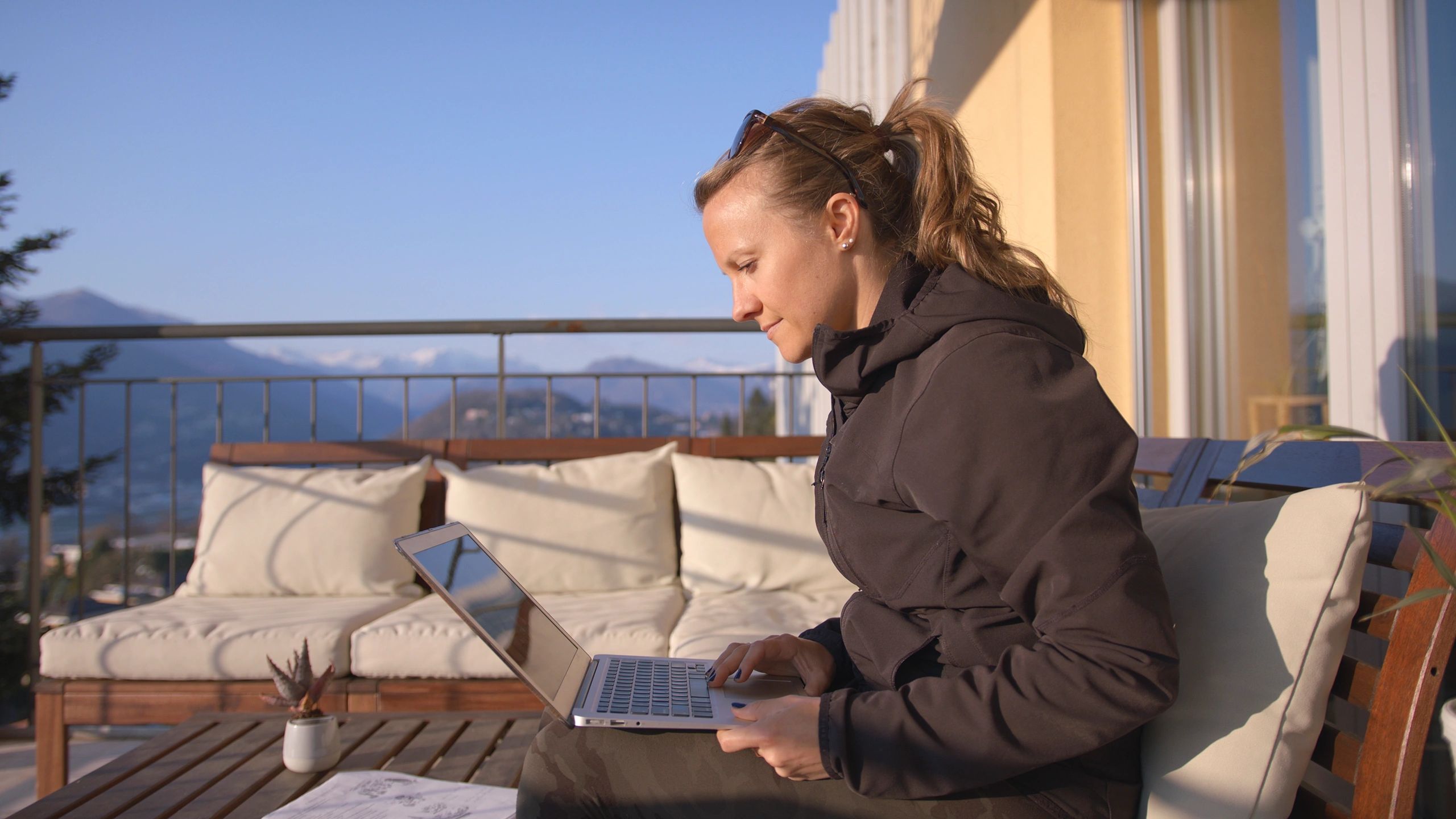 Host planning on a laptop and taking notes