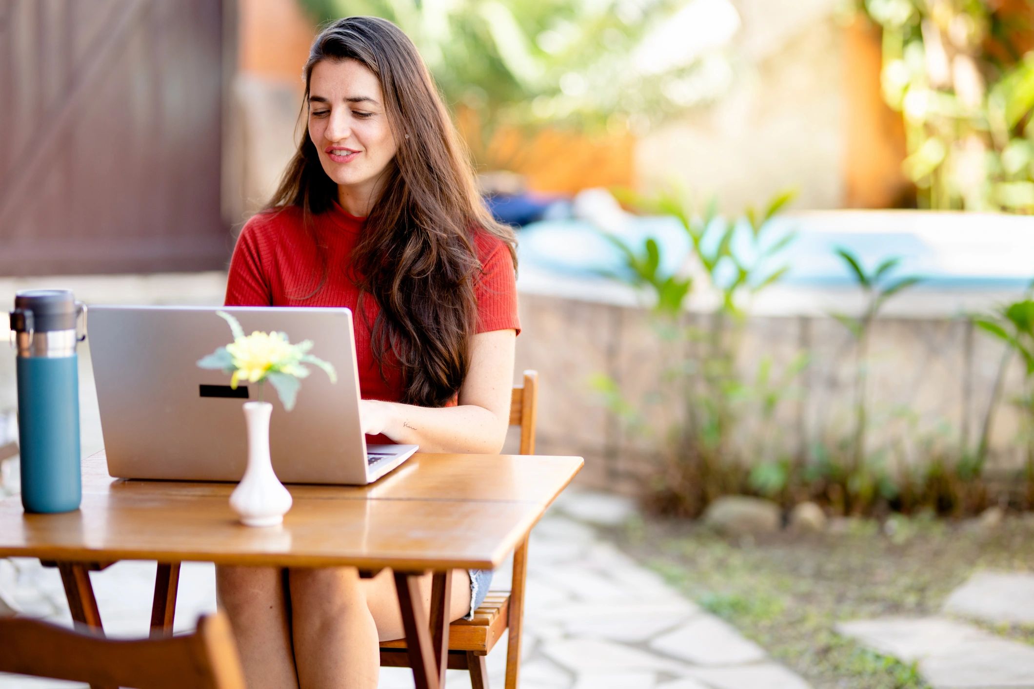 Woman working on a laptop outdoors