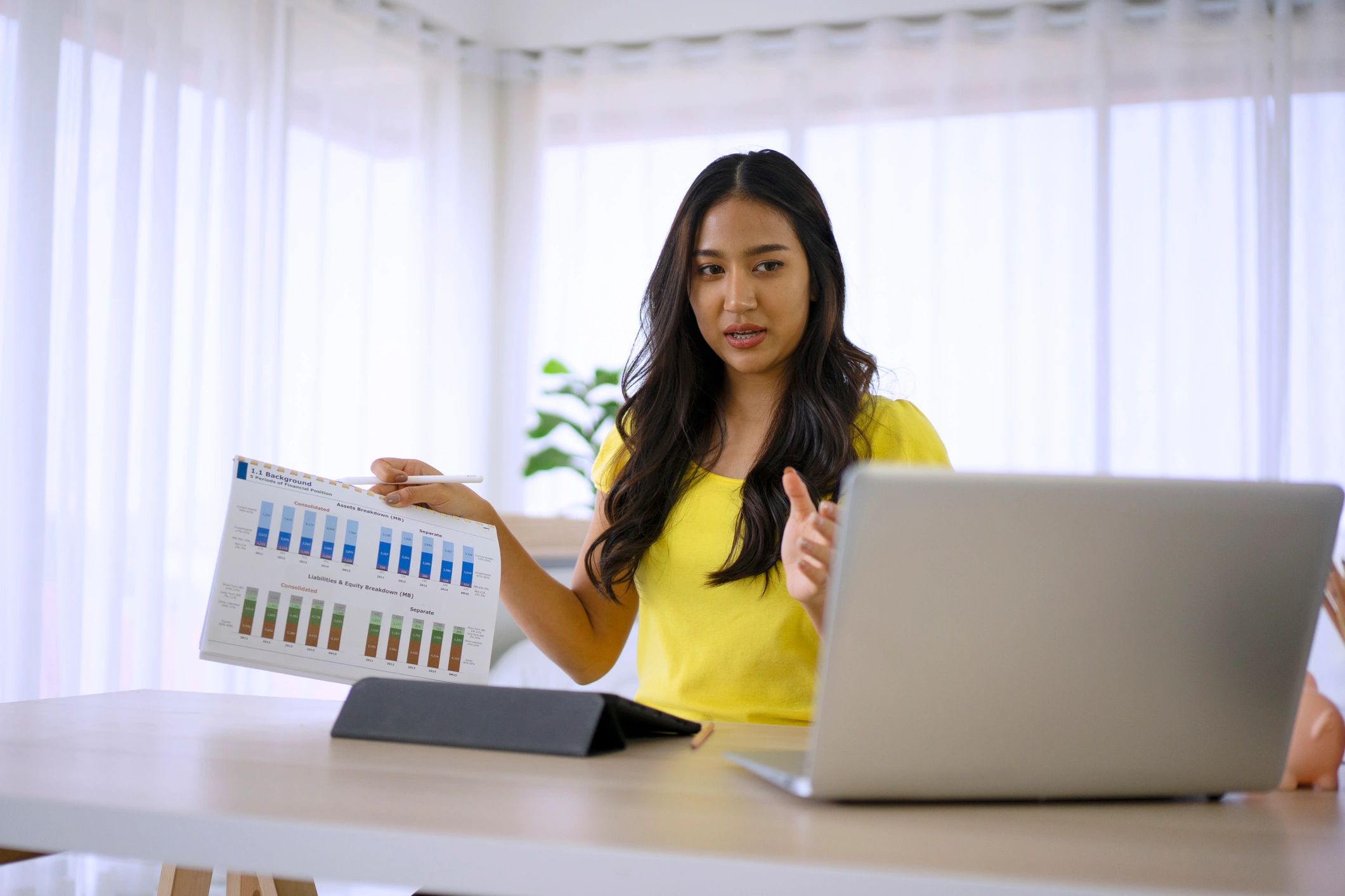 Host reviewing performance on a laptop