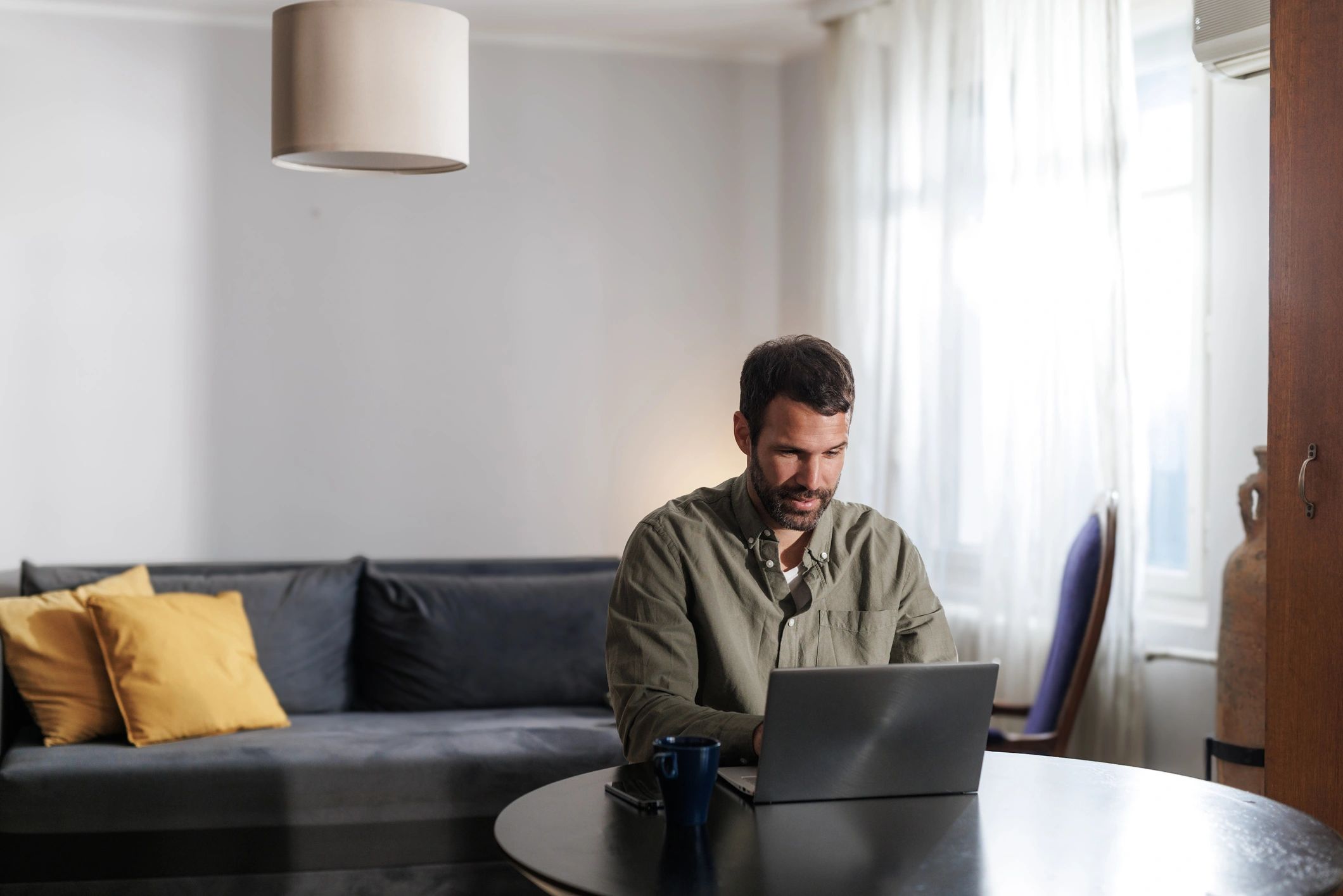 Host working on a laptop at home
