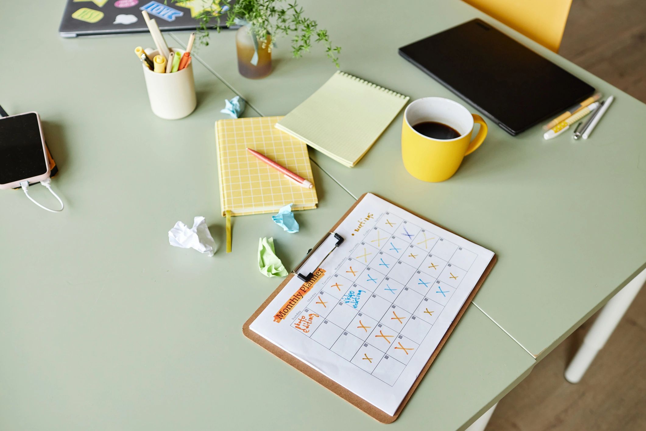 Monthly planner and work notes on desk