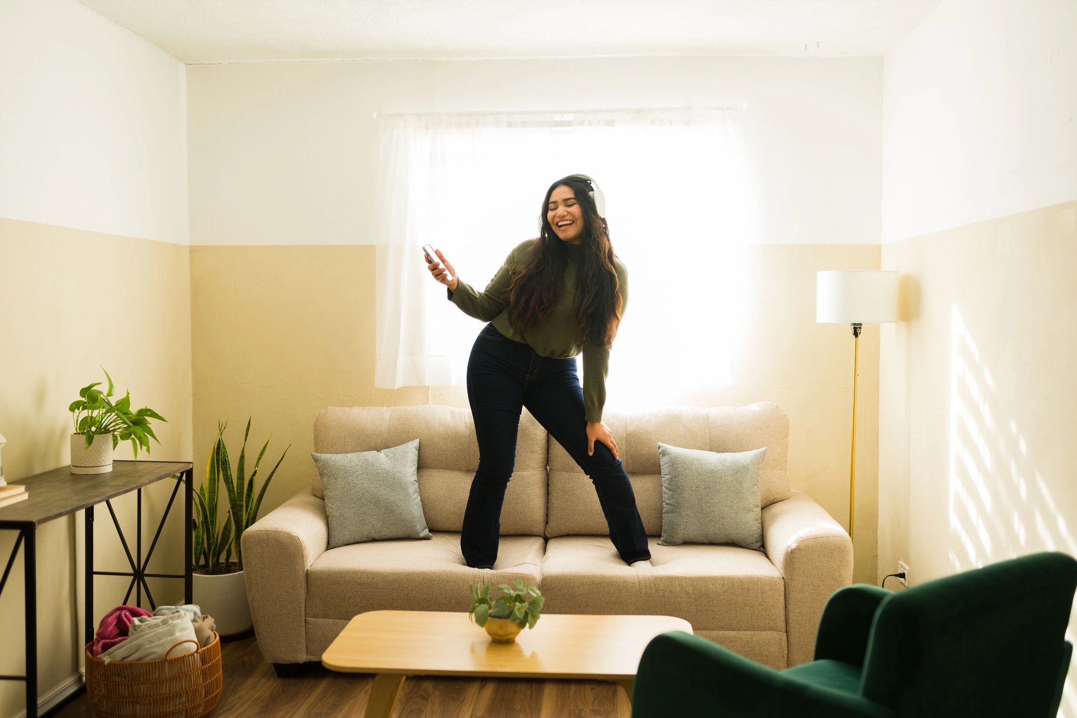 Woman relaxing on a sofa in a tidy living room